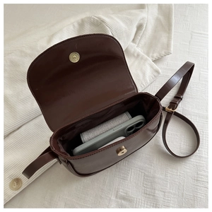Deep coffee saddle bag interior showing storage space for phone and accessories