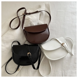 Three premium saddle bags in brown, black and white faux leather with gold buckles