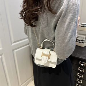 Minimalist white PU leather crossbody bag with gold chain strap shown on a model