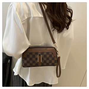 Vue détaillée du sac bandoulière marron monogramme avec motif à carreaux et dragonne