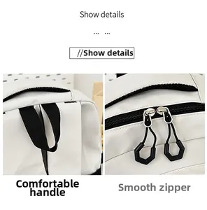 Détails du sac à dos montrant la poignée noire confortable et les doubles fermetures éclair