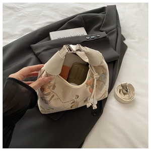 Internal view of beige fabric bag with floral prints and detachable shoulder strap