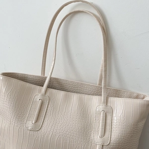 Large cream tote bag with elegant crocodile texture and long shoulder straps