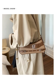 Detail of vintage canvas and brown leather crossbody bag with decorative silver buckles