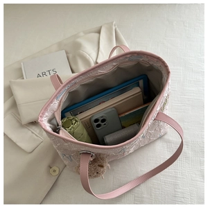 Detail of pink floral jacquard tote bag interior showing large storage capacity and bear charm