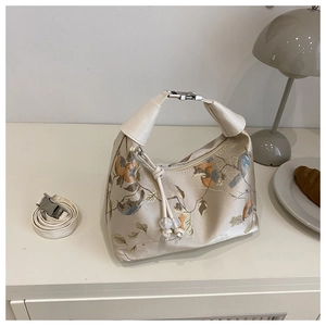 Detail of silk-texture bag with plum blossom embroidery and metal hardware