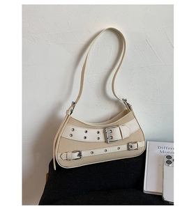 Close-up of retro canvas underarm bag with cream leather trim and silver metal buckles