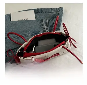 Internal view of a red and white floral mini bag showing storage space for phone and wallet