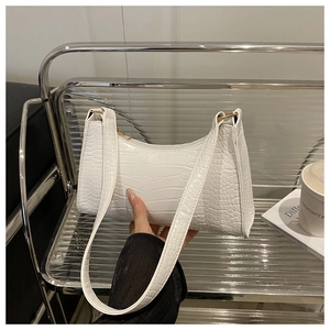 Close-up of white crocodile pattern shoulder bag with premium PU texture and gold metal buckle