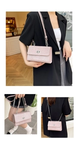 Borsa rosa con stampa coccodrillo mostrata a spalla e a tracolla indossata da una modella