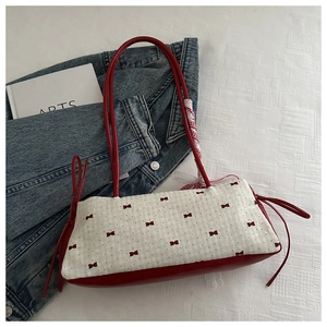 Détail de la poignée enrubannée et de l'imprimé nœud sur ce sac à bandoulière chic