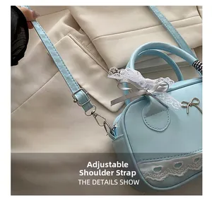 Detail showing adjustable leather strap and lace bow on the light blue Boston bag