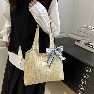 Large woven bucket tote bag with white leather trim and decorative scarf for summer