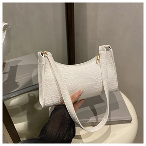 Detailed view of white crocodile pattern shoulder bag with elegant gold hardware