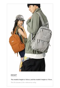 Water-resistant nylon backpacks in grey and orange shown on male and female models