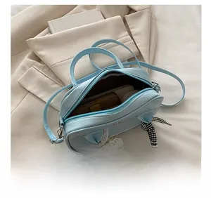 Internal capacity view of light blue lace Boston bag showing storage for phone and wallet