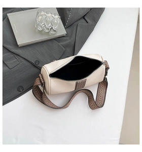 Top view of cream lychee leather boston bag with a patterned wide shoulder strap detail