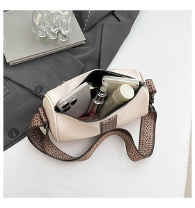Internal view of cream Boston bag showing capacity for phone and cosmetics