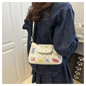 Detail of white polka dot tote bag with cute cat patches and smile embroidery