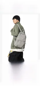Gray nylon backpack showing a high-capacity minimalist design on a male model