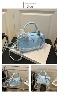 Detailed view of light blue bowling bag with white lace trim and ribbon decoration