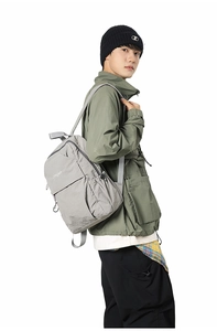 Close-up of light gray waterproof nylon backpack with Sanguo logo on a male model