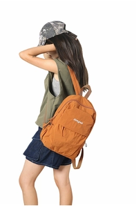 Side view of orange nylon backpack showing large front pocket and white logo detail
