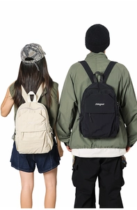 Detail view of the lightweight nylon texture and branded logo on the stylish backpacks