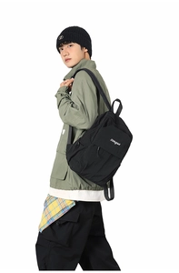 Close-up of black casual backpack with white logo print on green jacket utility model