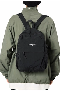 Detail of water-resistant black nylon backpack with front pocket and songuo white logo print