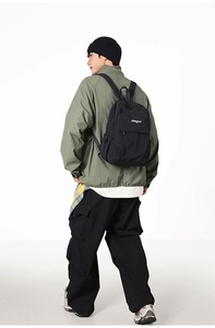 Back view of a large black Japanese style backpack worn by a male model for daily commute