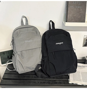 Detail of minimalist nylon backpacks in black and grey colors with adjustable shoulder straps