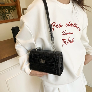 Glossy black crocodile pattern crossbody bag with silver chain strap and metal swivel lock