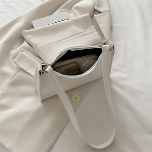 White faux leather baguette bag with crocodile texture and spacious inner compartment