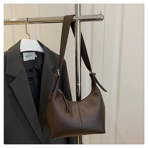 Detailed view of coffee brown hobo bag with sleek texture and golden metallic buckle