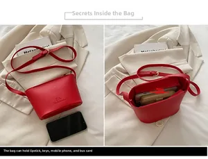 Detail view of red leather bucket bag interior showing capacity for daily essentials