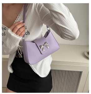 Detail of lavender PU leather underarm bag with silver metallic bow and matching strap