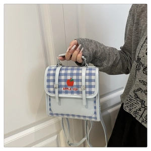 Detail of gingham pattern and apple embroidery on a versatile blue small backpack