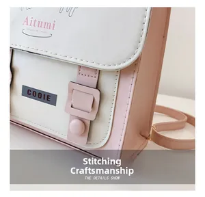 Détail du sac à bandoulière en cuir PU rose et blanc montrant les coutures fines et boucles
