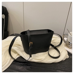 Close-up of black litchi grain leather bucket bag with gold metal buckle and logo