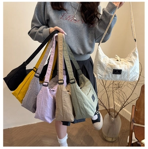 Detailed collection of colorful nylon tote bags with adjustable straps and logo patches
