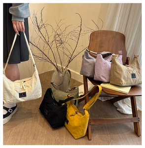 Multiple colors of wrinkled nylon shoulder bags in a casual minimalist display