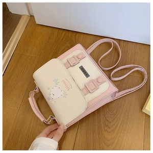 Detail of pink and white backpack featuring a cute cat illustration and metal buckle