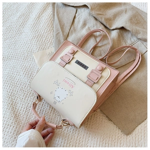 Pink and cream contrast backpack featuring a cute white cat motif and handle detail