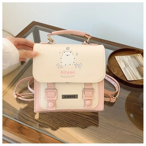 Close-up of cream and pink backpack featuring a cute puppy print and metal logo branding
