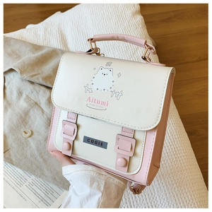 Close-up of cute cartoon samoyed print on cream and pink PU leather backpack