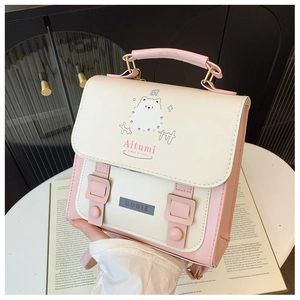 Detail of pink and white school backpack with cute cartoon bear and buckle accents
