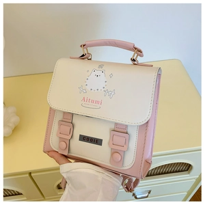 Close-up of pink and white contrast PU leather bag with cute cartoon puppy illustration