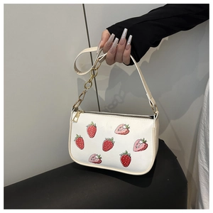 Detail der weißen PU-Handtasche mit Erdbeerdruck und goldener Kette für Damen