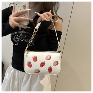 Detail of white PU shoulder bag with strawberry print and gold chain strap